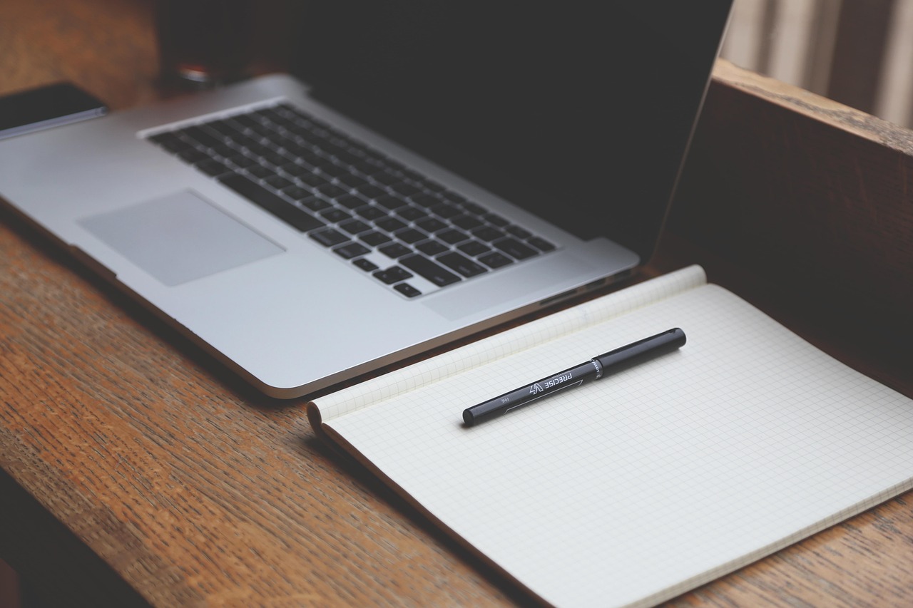 person purchasing lottery tickets on laptop at home desk
