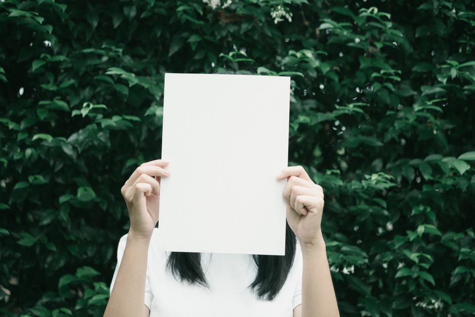 person holding lottery ticket hiding face privacy concept